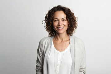 medium shot portrait of a confident Israeli woman in her 40s wearing a chic cardigan against a white background