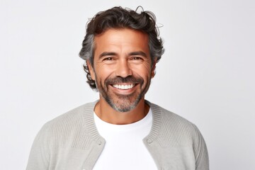 Obraz premium portrait of a Mexican man in his 40s wearing a chic cardigan against a white background