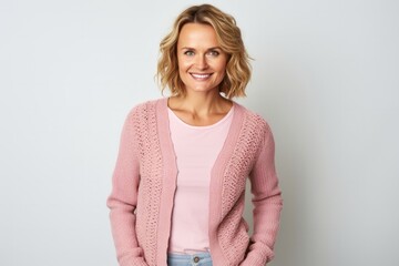 portrait of a Polish woman in her 30s wearing a chic cardigan against a white background