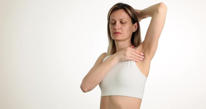 Woman feels pain in armpits and makes diagnosis. Armpit pain causes symptoms and treatment