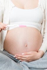 Pregnant woman with insulin syringe in home on bed. Pregnant diabetes concept