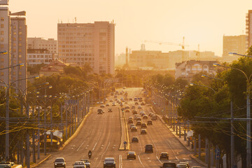 An avenue of the city on sunset in summer - obrazy, fototapety, plakaty