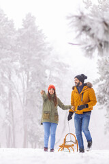 Couple having fun sledging on winter vacation