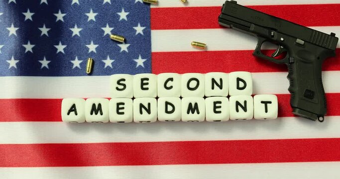 Gun on American flag. Gun laws in USA and second amendment. Pistol and self-defense