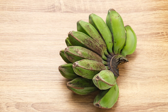 Raw Kepok Banana (Pisang Kepok) on wooden table