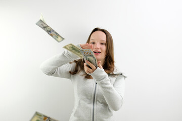 Arrogant wealthy girl scattering dollars with proud haughty expression, boasting rich life,...