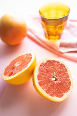 Healthy breakfast or snack with pink grapefruit. Background image with pink and orange tones. Fruit, vitamins, and homemade food.