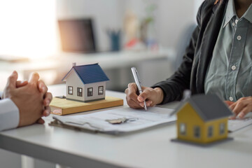 Agents and clients discuss contracts to buy, insure, or borrow real estate or assets. along with...
