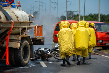 Rescue workers wear bio hazard suits. With an oxygen tank inside Entering the scene of a car crash where toxic substances were leaking. There was motorcycle and injured people in the area of incident