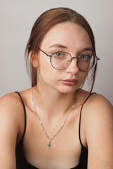 Portrait of a girl with glasses on a white background