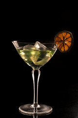 cocktail and drinks in crystal glasses with liquors and bottles on the bar