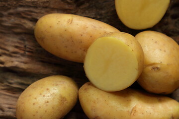 Fresh ripe Potatoes on wooden table. Top view with copy space