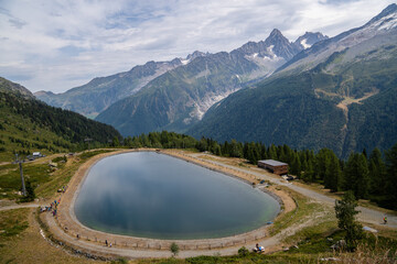 Champex-Lac iconic swiss village with beautiful lake aerial shot. Breathtaking panorama on a sunny morning