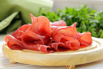 traditional beef jerky bresaola on a wooden board