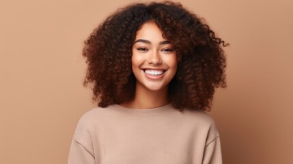 A radiant teenage girl exudes happiness against a soft, neutral studio backdrop.