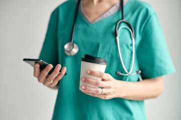 Crop doctor with smartphone and coffee to go