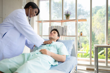 Doctor examining patient in hospital ward. Medical healthcare and doctor staff service concept.