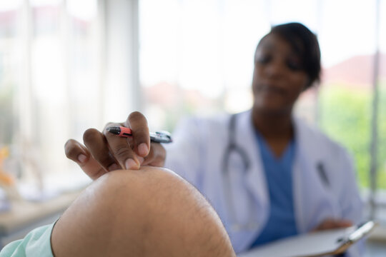 Doctor Examining Knee Joint Function Of Patient In Hospital, Medical Health Care