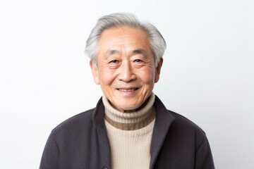 Cheerful senior man with gray hair smiling in white background