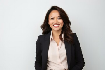 Cheerful businesswoman with curly hair and a radiant smile in studio portrait