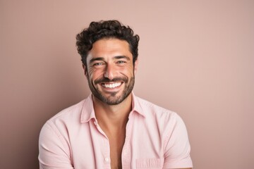 Happy smiling individual with facial hair in studio portrait