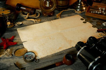 Treasure island concept on a wooden table background. Sheet of paper for text or map
