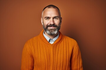 Confident mature man with a beard and casual clothing smiling happily