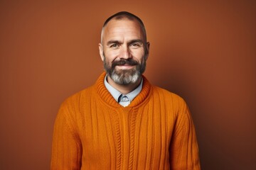 Fototapeta premium Confident mature man with a beard and casual clothing smiling happily