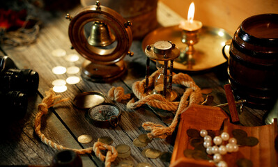 Sea concept on a wooden table background. Chest with treasure on pirat table