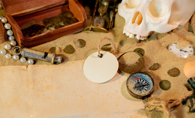 Treasure island theme. Vintge round label on the sand among shells, stones and marine elments....