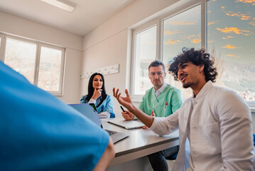 A medical team of doctors discussing at a meeting in the conference room.