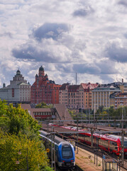 Rail way two trains and old apartment houses with domes at the channel Karlbergskanalen, an autumn...