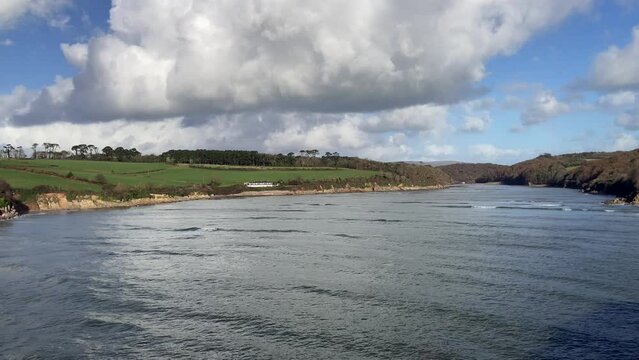 View of the Erme Estuary at high tide on the Devonshire coastline. Looking towards Wonwell and Coastguards beaches with trees and rolling hills in the background - Nr Kingston, Devon, UK