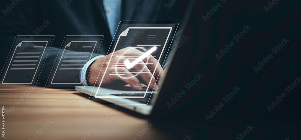 Poster Businessman using laptop computer and touching to online electronic paper for approve ISO quality document control certification and project approval concept.