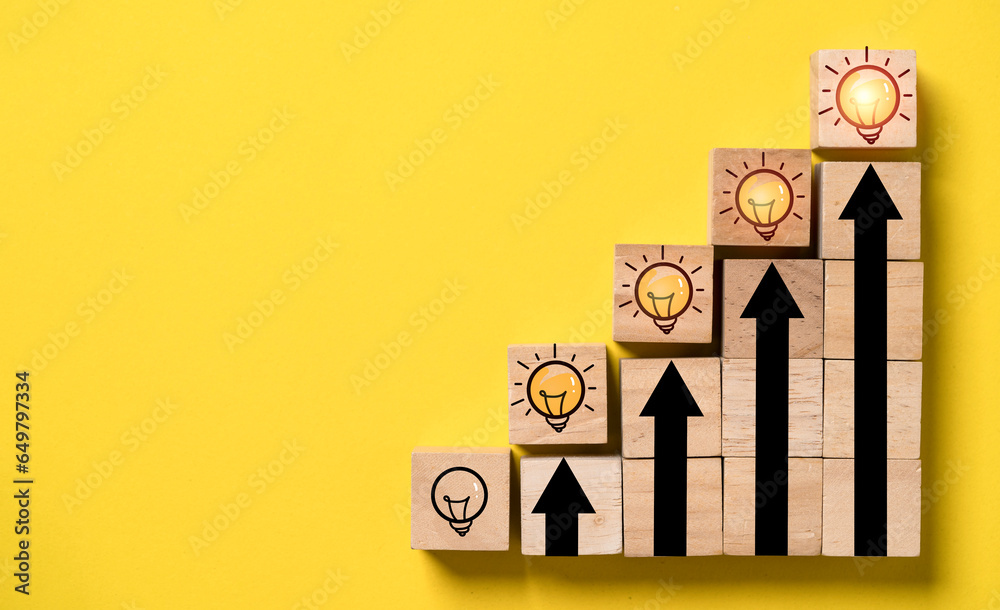 Poster glowing lightbulb on the top of up arrow and wooden block cube for human development of problem solv