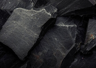 A mysterious dark natural stone texture background with a subtle, textured surface.
