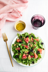 Rocket (arugula) and lamb's lettuce salad with grapefruit, pomegranate seeds, black olives, capers, walnuts, and mustard vinaigrette dressing