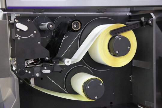 Thermo labels roll inside the label printer closeup
