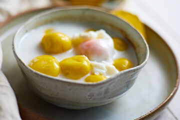Dumplings in coconut cream on white background.