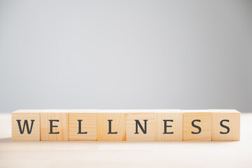 Wooden cube block features the word wellness, encapsulating concept of mental health, relaxation, and overall wellbeing. Ideal for promoting a healthy lifestyle and stress reduction. wellness concept