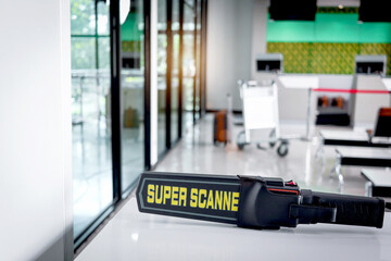 Metal weapon detector scanner at entrance airplane gate, the tool checking passenger after walking through procedure of physical inspection. Airport security checking process before flight. © Stella