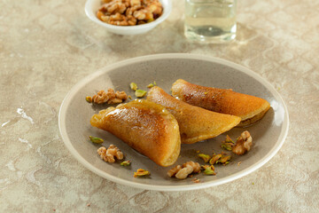 Qatayef with nuts and dates, oriental Arabic sweets, served hot with sugar syrup  6