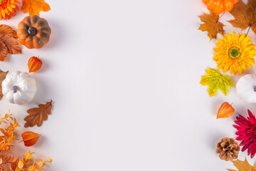 Autumn holidays background. Thanksgiving Day greetings card. Multi-colored pumpkins, autumn leaves...