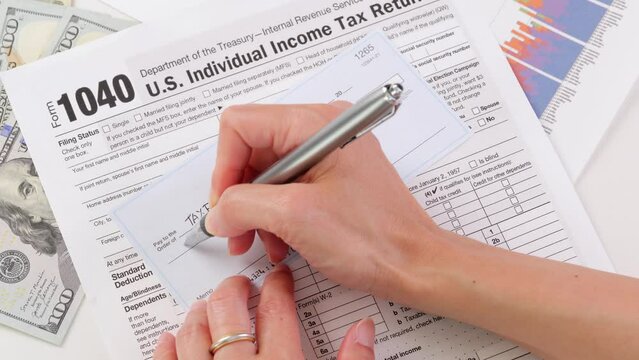 Close-up shot of a check being written for taxes.