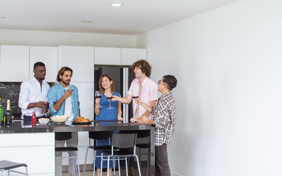 Group of diverse friends or people wearing casual clothes, smiling with happiness, holding glass of wine, toasting for party celebration at cozy home. Event, New Year, birthday Concept.