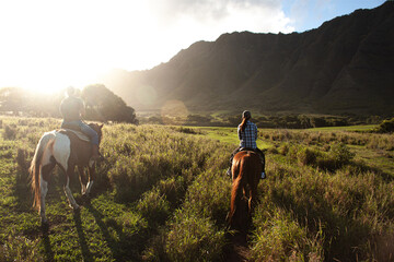 Riding at Kualo Aranch Park in Hawaii, where the sun sets - obrazy, fototapety, plakaty