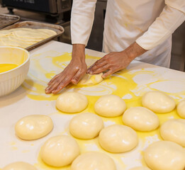 Obraz na płótnie Canvas A cook prepares bread from dough in a restaurant