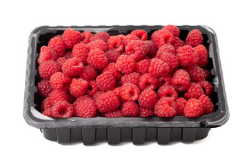 Raspberry in a container isolated on a white background. Close-up