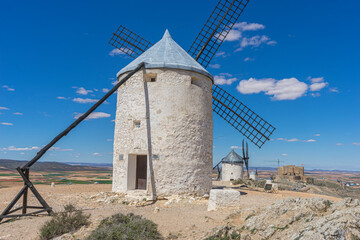 Historic mills, Spanish countryside backdrop. An elegant ballet of architecture and nature in Toledo's heart