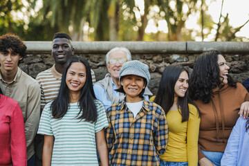 Crowd of multi generational people smiling in front of camera outdoor - Community, multiracial...